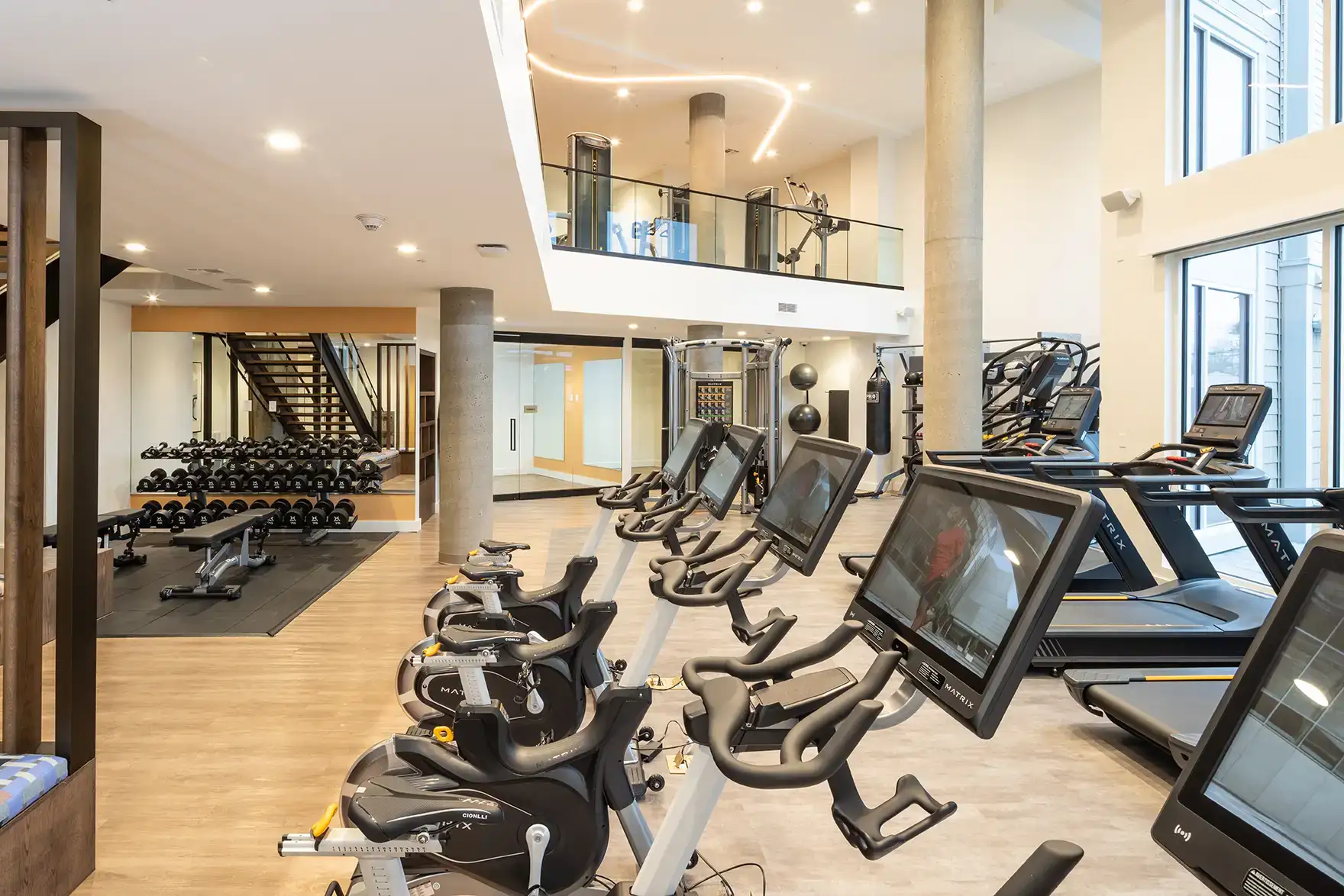 Apartment fitness center with indoor cycles, treadmills and a free-weight area
