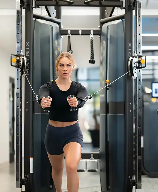 Resident using a cable machine in a fitness center